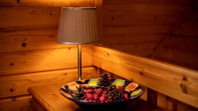 a bowl of fruit on a table next to a lamp at The New Farmhouse in Biggar