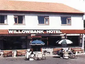 a willowbank hotel with people sitting outside of it at Willowbank Hotel in Largs