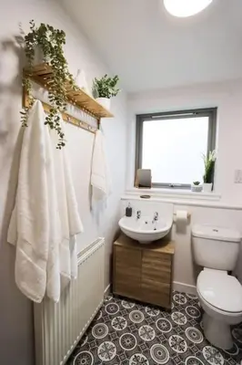 a bathroom with a toilet and a sink and a window at City Views by the Castle, Free Designated Parking. in Stirling