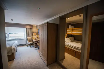 a hotel room with a bunk bed and a desk at Bowfield Hotel and Spa in Howwood