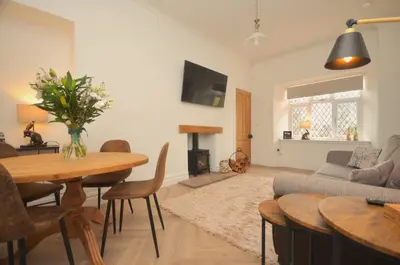 a living room with a table and a couch at The Gate Lodge in Helensburgh