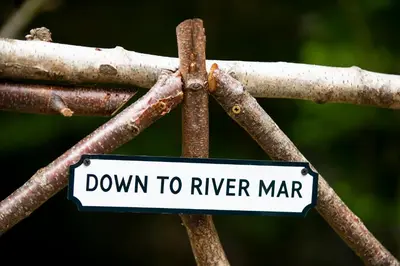a sign that says down to river marrar at The Mar Huts - The Conic Hut in Drymen