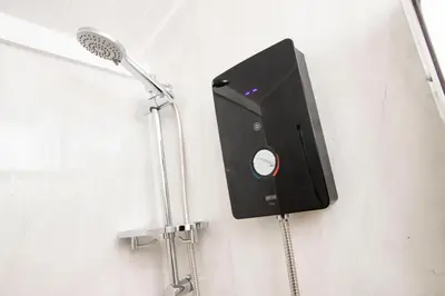 a bathroom with a shower with a speaker on the wall at The Mar Huts - The Conic Hut in Drymen