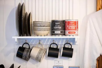 a cupboard with a rack with cooking utensils at The Mar Huts - The Conic Hut in Drymen