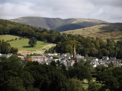 a small town in the middle of a valley with hills at Beautiful Cosy Holiday Home in Gorgeous Location - Pass the Keys in Beattock