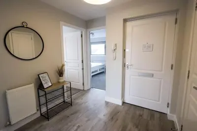 a hallway with a door and a mirror on the wall at City Retreat by the Castle Free Designated Parking in Stirling
