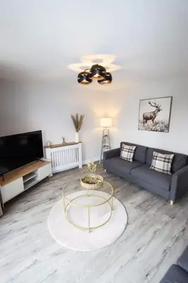 a living room with a couch and a table at City Retreat by the Castle Free Designated Parking in Stirling