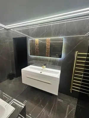 a bathroom with a white sink and a mirror at Large Modern Family Home in Murrayfield - Very close to City Centre - 10 mins by Direct Bus - Private Driveway & Garden in Edinburgh