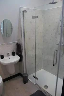 a bathroom with a shower and a sink at Tigh Na Beithe in North Ballachulish