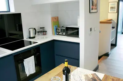 a bottle of wine sitting on a table in a kitchen at Tigh Na Beithe in North Ballachulish