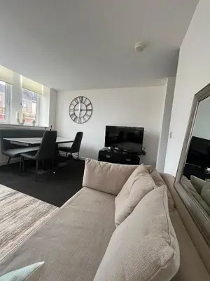 a living room with a couch and a table at The M Rooms at 144 in Kirk of Shotts