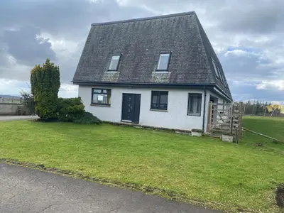 a white house with a black roof on a yard at The Annex at Meeks Park immaculate 2 bed in Alloa