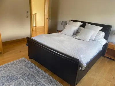 a bedroom with a large bed with white sheets and pillows at The Annex at Meeks Park immaculate 2 bed in Alloa