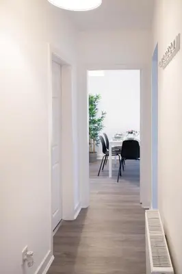 a hallway with a table and a dining room at 2 Bedroom Apartment-Free Parking-by Holiday Homes in Wishaw