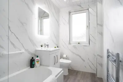a white bathroom with a sink and a toilet at 2 Bedroom Apartment-Free Parking-by Holiday Homes in Wishaw