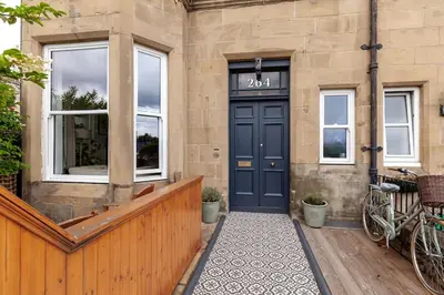 a front door of a house with a blue door at Beautiful Victorian Apartment close to the Botanical gardens, Free parking! in Edinburgh