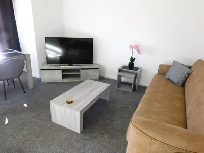 a living room with a couch and a flat screen tv at No 54 - New & delightful 3 bed house in East Kilbride in Glasgow