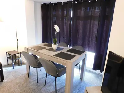 a dining room table with chairs and a vase with flowers on it at No 54 - New & delightful 3 bed house in East Kilbride in Glasgow