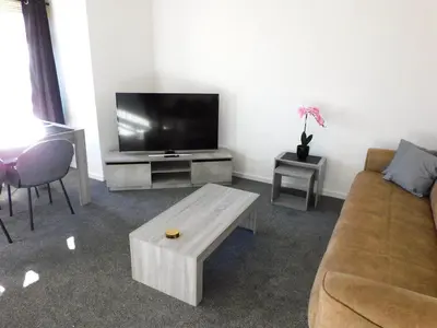a living room with a couch and a flat screen tv at No 54 - New & delightful 3 bed house in East Kilbride in Glasgow