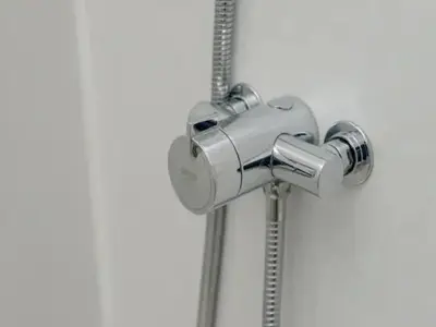 a silver shower head with a shower curtain at Spacious Murrayfield Flat - Pass the Keys in Edinburgh