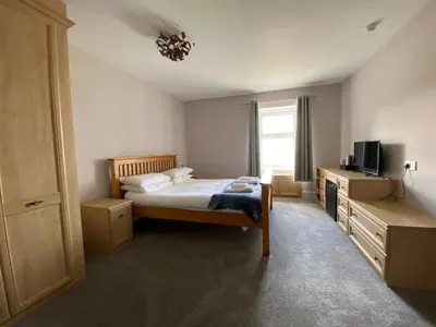 a bedroom with a bed and a television in it at Bunessan Inn in Bunessan