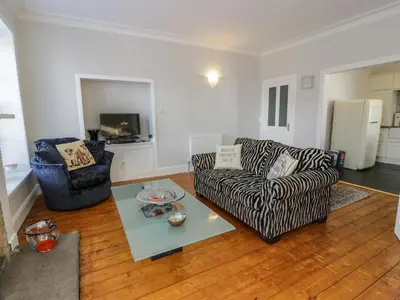 a living room with a couch and a table at Lower Neuk in Dunfermline