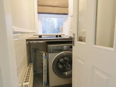 a washing machine in a kitchen with a window at Lower Neuk in Dunfermline