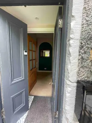 a hallway of a house with a blue door at Carronvale. 3 Bedroom Oban Apartment. in Oban