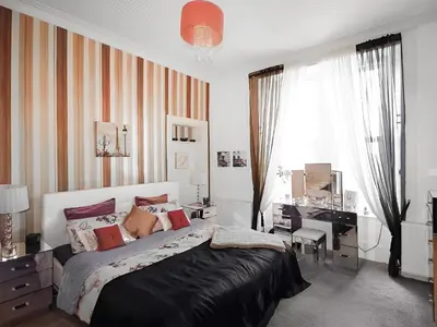 a bedroom with a large bed and a desk and window at Island Seaview Villa in Rothesay