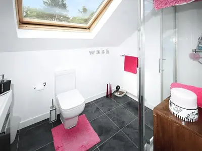 a bathroom with a toilet and a glass shower at Island Seaview Villa in Rothesay