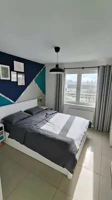 a bedroom with a large bed and a large window at La Casita, Your Home Away from Home - Free Parking in Glasgow