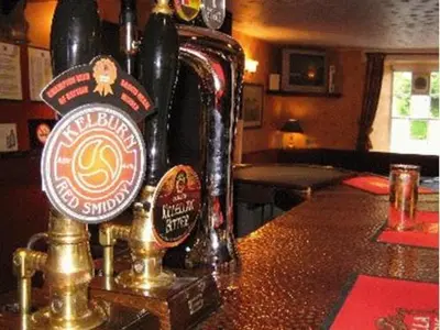 a bottle of beer sitting on top of a bar at Uplawmoor in Uplawmoor