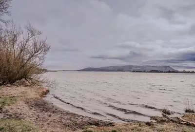 a large body of water with mountains in the background at The Kinross Residence in Kinross