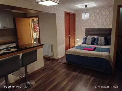a hotel room with a bed and a desk at Open space studio in Shawlands in Glasgow