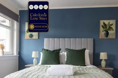 a bedroom with blue walls and a bed with green pillows at Winton House in Glasgow