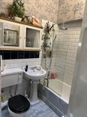 a bathroom with a toilet and a sink and a shower at Very central 2 bedroom flat in World Heritage Site in Edinburgh