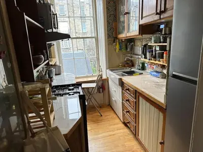 a kitchen with a refrigerator and a stove top oven at Very central 2 bedroom flat in World Heritage Site in Edinburgh