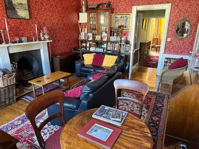 a living room with a couch and a table at Very central 2 bedroom flat in World Heritage Site in Edinburgh