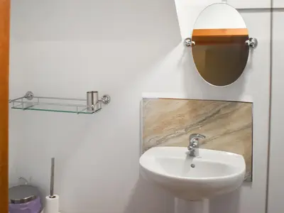 a bathroom with a sink and a mirror at Bayview in Kentallen