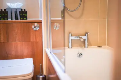 a bathroom with a shower and a sink and a toilet at The Knight Residence by Mansley in Edinburgh