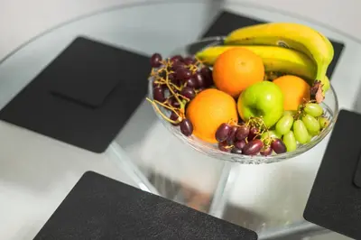 a bowl of fruit on top of a glass table at The Knight Residence by Mansley in Edinburgh