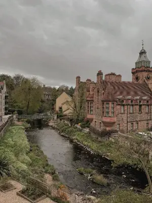 an old brick building with a river in front of it at Loggia Studio in Edinburgh