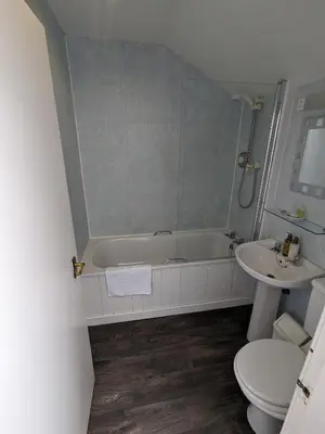 a bathroom with a tub and a toilet and a sink at Lochranza Country Inn in Lochranza