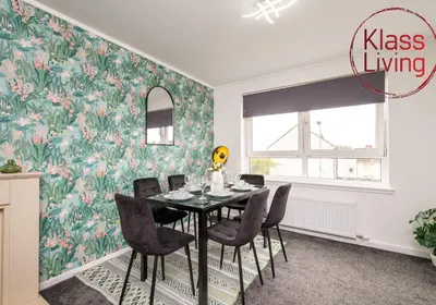 a dining room with a table and chairs at Aitkenhead house by Klass Living in Coatbridge