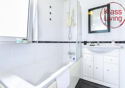 a white bathroom with a sink and a mirror at Aitkenhead house by Klass Living in Coatbridge