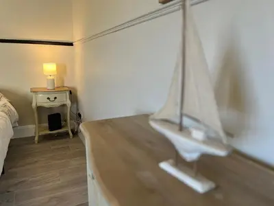 a bedroom with a bed and a table with a lamp at Scottish Nest in the heart of East Kilbride 10mins from Hairmyres Hospital in East Kilbride
