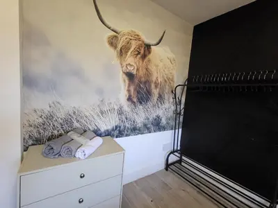 a mural of a bull on a wall in a room at Scottish Nest in the heart of East Kilbride 10mins from Hairmyres Hospital in East Kilbride