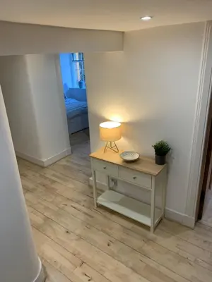 a room with a table and a lamp on a floor at The Inverleither in Edinburgh