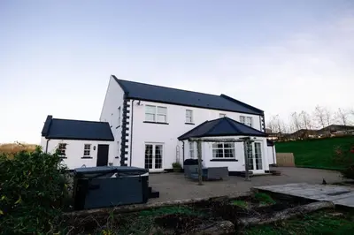 a white house with a gazebo in front of it at Coylebrae House in Ayr