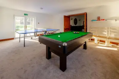 a room with a pool table and two tables at Coylebrae House in Ayr